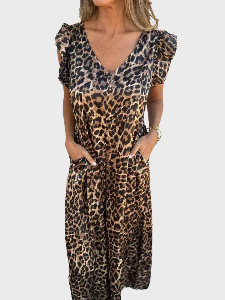 A woman wearing a leopard print dress with puffed sleeves and a v-neck.